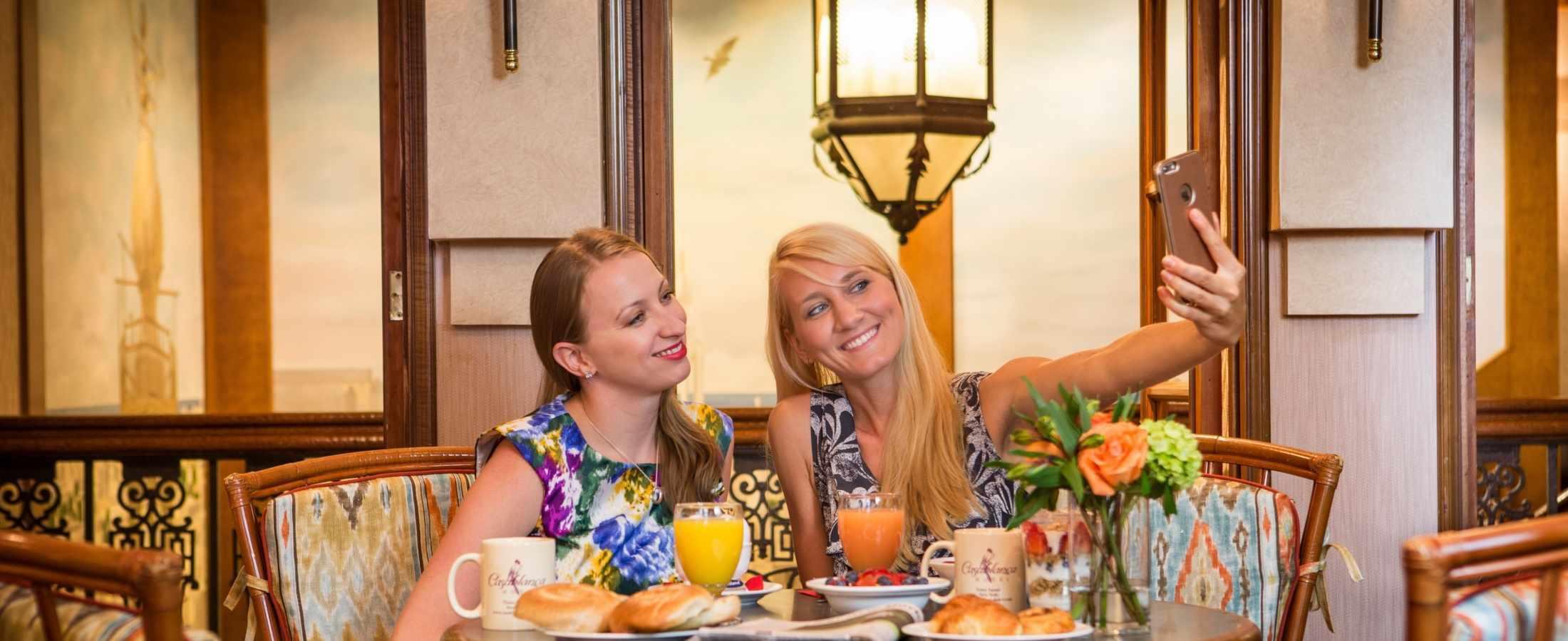 Two women taking a selfie while enjoying breakfast in Rick's Cafe.