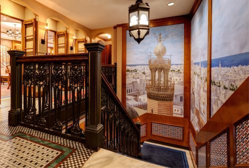 Feel the Moroccan flair with a picturesque mural as you walk up the steps to Rick's Cafe.