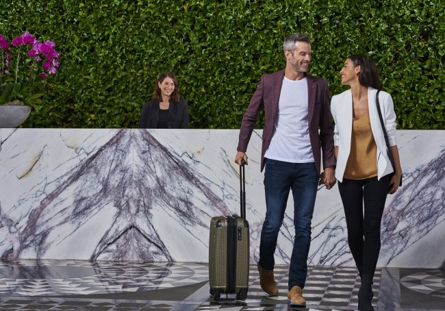 Couple toasting in guest room at Hotel X Toronto